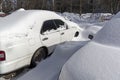 Snow covered the cars parked near the house. Royalty Free Stock Photo
