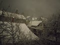 Snowy winter night, houses covered by a huge amount of snow