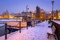 Snowy winter in the old town of Gdansk with frozen Motlawa river, Poland