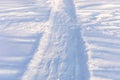 Snowy winter pathway with shoes prints. Human feet traces in snow. Hiking, local travel, staycation Royalty Free Stock Photo