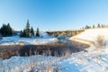 Snowy winter river landscape with metal bridge Royalty Free Stock Photo