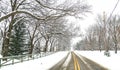 Snowy Winter Road Scene with Yellow Stripe