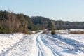 Snowy winter road with tire markings Royalty Free Stock Photo