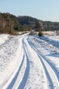 Snowy winter road with tire markings Royalty Free Stock Photo