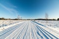 Snowy winter road with tire markings Royalty Free Stock Photo