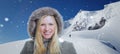 Snowy winter scenery with high moutains and a smiling attractive woman