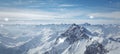 Snowy winter scenery with high moutains and snowflakes