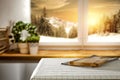 Kitchen table top with space for products and decorations.  Snowy winter sunshine mountains landscape outside the window. Royalty Free Stock Photo