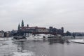 Snowy winter view of Wawel Castle seen from across the Vistula River. Its a cold, cloudy day.Krakow, Poland Royalty Free Stock Photo