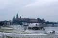 Snowy winter view of Wawel Castle seen from across the Vistula River. Its a cold, cloudy day.Krakow, Poland Royalty Free Stock Photo