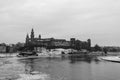 Snowy winter view of Wawel Castle seen from across the Vistula River. Its a cold, cloudy day.Krakow, Poland. Black and white Royalty Free Stock Photo
