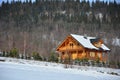 Snowy wooden house in mountains Royalty Free Stock Photo