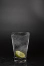 Soad water in glass with lime on black background. cool soda water and lime with copy space