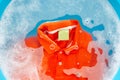 Soak a cloth before washing, Orange polo shirt. Royalty Free Stock Photo