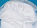 soak white T-shirt in detergent solution, laundry cloth cleaning with washing powder in tub Royalty Free Stock Photo