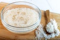 Soaked rice, grain, cloudy liquid water in glass bowl on wooden background Royalty Free Stock Photo