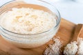 Soaked rice, grain, cloudy liquid water in glass bowl on wooden background Royalty Free Stock Photo