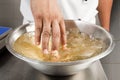 Soaking the gelatine leaves in a bowl of water Royalty Free Stock Photo