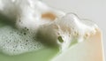 Soap bar with foam on white background, close-up Royalty Free Stock Photo