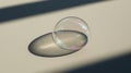 Soap bubble resting on a surface with dramatic shadows Royalty Free Stock Photo