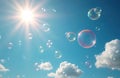 Soap bubbles float serenely in clear blue sky with bright sun rays shining. White clouds drift peacefully during daytime. Shiny Royalty Free Stock Photo