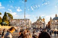 Soap bubbles flying on Piazza del Popolo, People Square in Rome full of happy positive people, tourists and locals with Roman Royalty Free Stock Photo