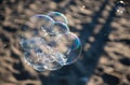 Soap Bubbles on Sandy Beach