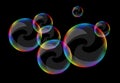 Soap bubbles set against a black background clear curls Royalty Free Stock Photo