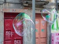 Soap Bubbles in a Street near Colofrul Doors Royalty Free Stock Photo