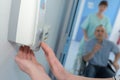 Soap dispenser with hand pushing on it Royalty Free Stock Photo