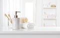 Soap dispenser, toothbrushes and white towel on bathroom counter interior