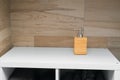 Soap dispenser on white shelf. Copy space. Cleanliness, routine, and simplicity in modern interior. Royalty Free Stock Photo