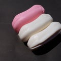 Pink and white soap on the black background