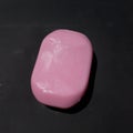 Pink and white soap on the black background