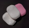 Pink and white soap on the black background