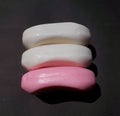 Pink and white soap on the black background