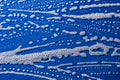 Soap foam on a blue background Royalty Free Stock Photo