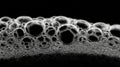 Soap foam creating an abstract black and white texture with many bubbles forming a mesmerizing pattern on a dark background, Royalty Free Stock Photo
