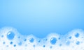 Soap foam overlying on the background of a blue water color Royalty Free Stock Photo