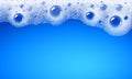 Soap foam overlying on the background of a blue water color