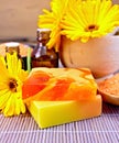 Soap homemade and oil with calendula on bamboo Royalty Free Stock Photo