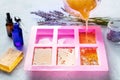 Soap making at home. Liquid glycerin with the additives of peels and flowers