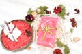 Soap with a marble texture next to the red bath salt in a coconut shell Royalty Free Stock Photo