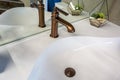 Soap and shampoo dispensers near Ceramic Water tap sink with faucet in expensive loft bathroom Royalty Free Stock Photo