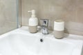 Soap and shampoo dispensers near Ceramic Water tap sink with faucet in expensive loft bathroom Royalty Free Stock Photo