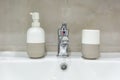 Soap and shampoo dispensers near Ceramic Water tap sink with faucet in expensive loft bathroom Royalty Free Stock Photo