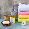 Soap, shampoo, shower gel, lotion and cotton towels on stone counter table in a bathroom. Royalty Free Stock Photo