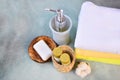 Soap, shampoo, shower gel, lotion and cotton towels on stone counter table in a bathroom. Royalty Free Stock Photo