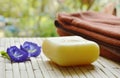 Soap and towel with blue pea violet flower on bamboo mat Royalty Free Stock Photo