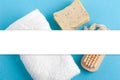 Soap, white towel and wooden brush